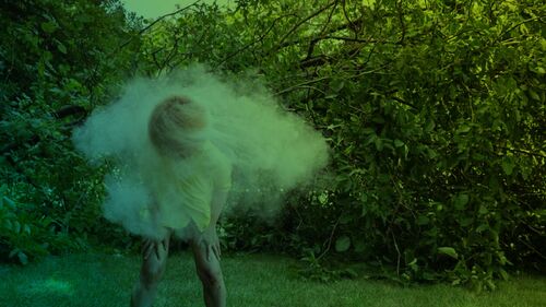 Green image of a figure dancing