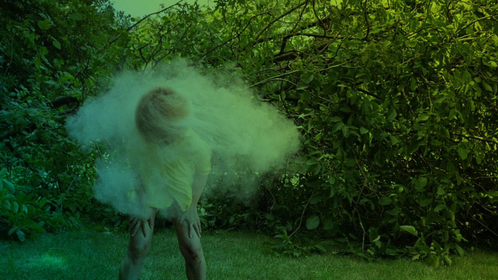 Green image of a figure dancing