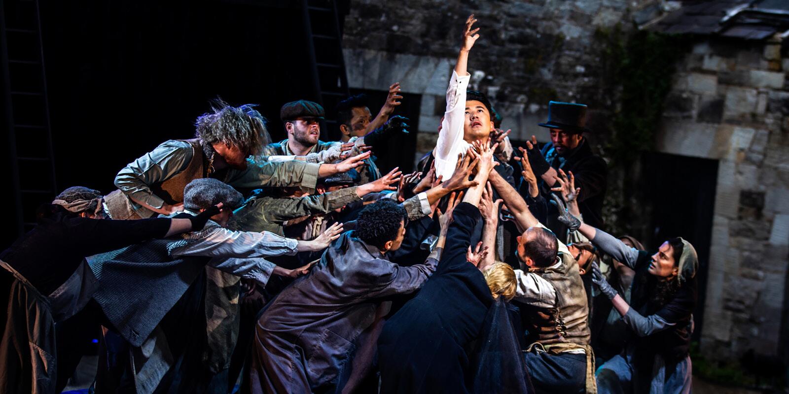 Cast members in movement gathered close