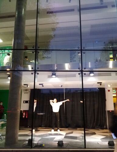 Ben Sullivan in movement, framed by the windows of The Science Gallery