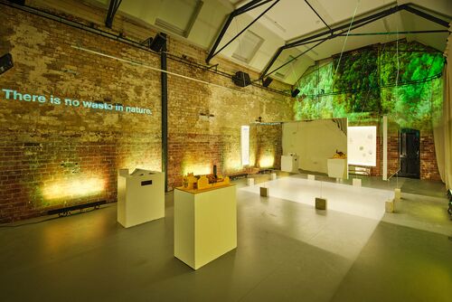 Models on podiums in the CoisCéim studio with exposition panels hanging in the background