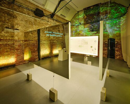 Exposition panels with mirrored surfaces on the back hanging in the CoisCéim studio