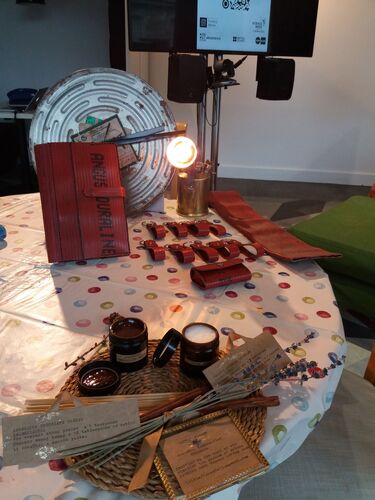 A table with cosmetics and recycled leatherwork laid out
