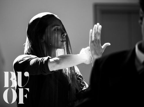 Mia DiChiaro in movement with a sheer veil over her face