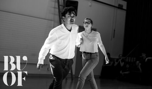 Two figures in movement in black and white