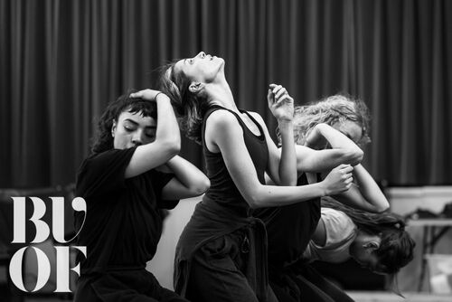 Four figures in movement in black and white