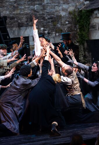 Cast members in movement gathered close