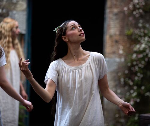 Mia DiChiaro dressed in white looking upward