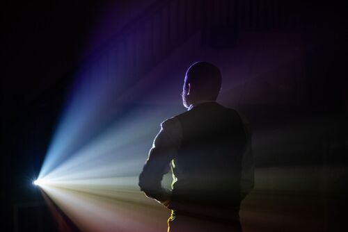 Jonathan Mitchell silhouetted in a beam of light