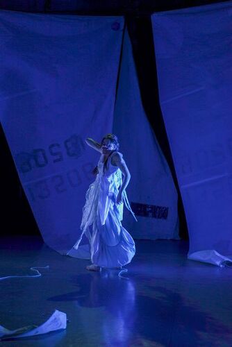 Rosie Stebbing in movement lit in blue