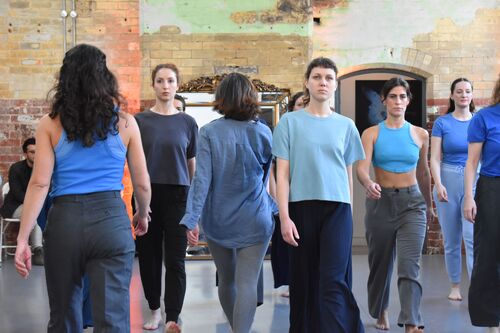 An ensemble of participants walking in formation