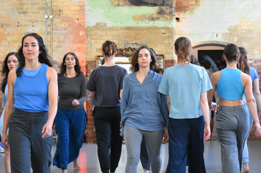 An ensemble of participants walking in formation