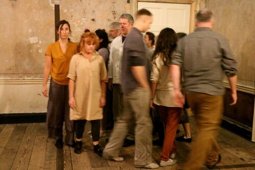 An ensemble of figures moving in a tight pack