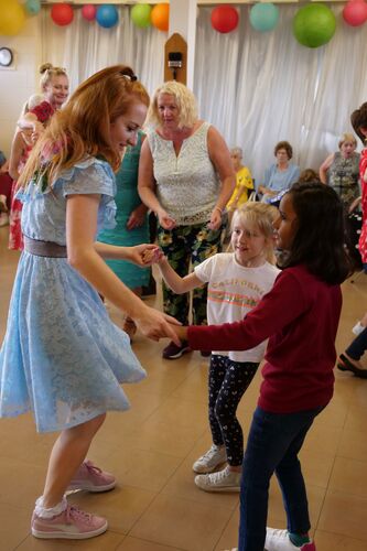 Olwyn Lyons dancing with two young participants holding hands