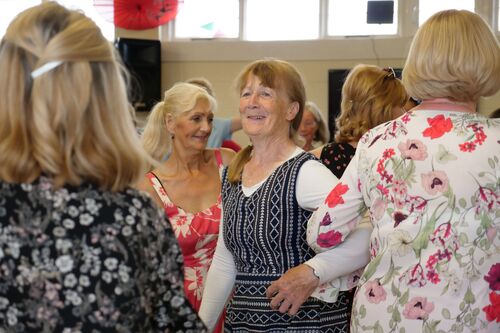 People dancing with linked arms