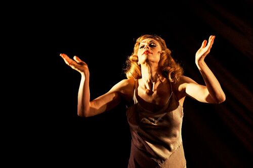 A figure in movement with palms facing up