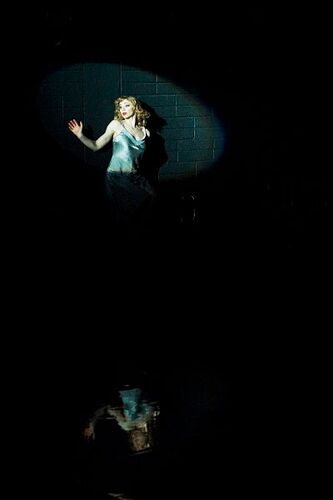 A figure in movement under a splotlight