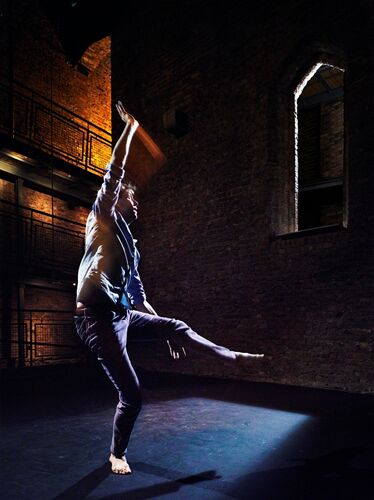 A figure in movement, spotlit