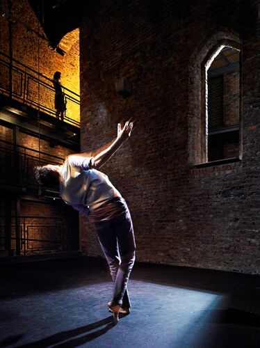 A figure in movement spotlit