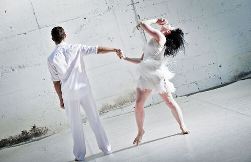 Two figures holding hands with one in movement