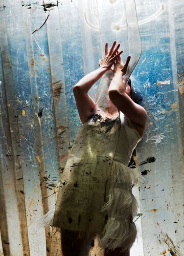 A figure in movement through a curtain of heavy plastic