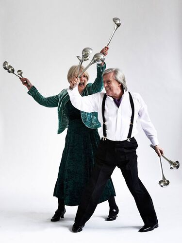 Two figures dancing together with hands full of ladles
