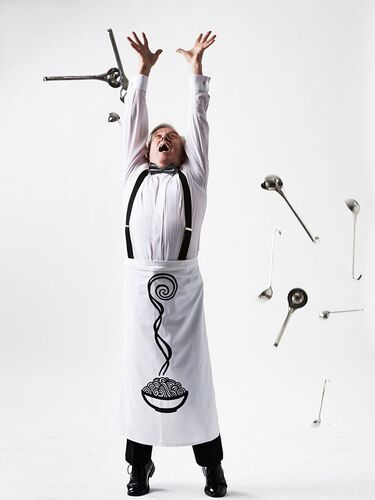 A figure with arms raised up and kitchen utensils raining down around