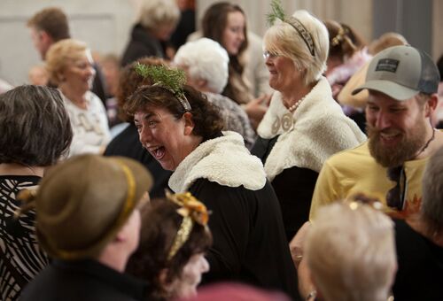 A close up of audience and participants laughing together