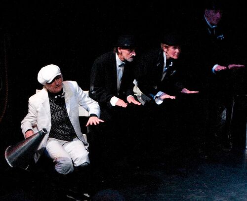 Four participants positioned in a line with three holding their hands out, palms down