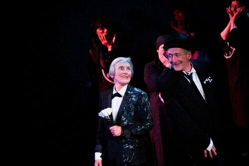 Two participants on stage smiling to each other