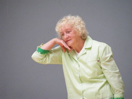 A participant in movement with the back of their hand to their face