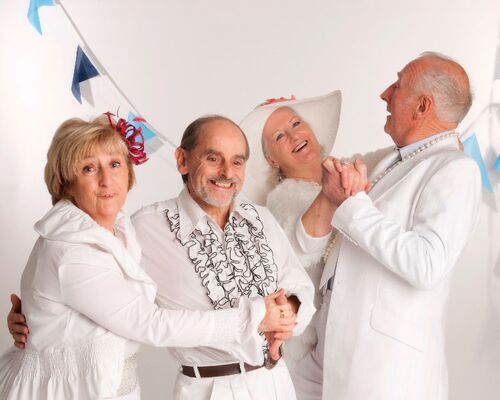 Two pairs of participants dressed all in white in movement together