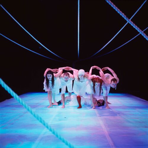 Five figures in a line in movement with torsos bent and faces raised towards the camera