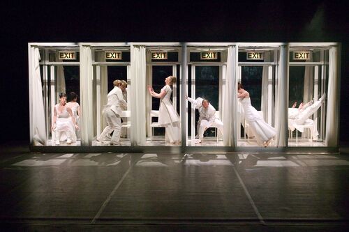 A row of six cubicles with EXIT signs above them each with a figure inside in movement