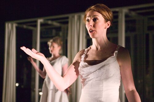 A close up of a figure in all white formal dress speaking