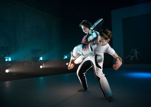 Two figures in movement on stage