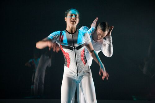 Two figures in movement on stage
