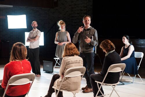 David Bolger standing in the performance space speaking to audience