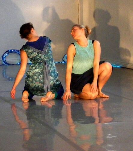 Two participants in movement together on the floor
