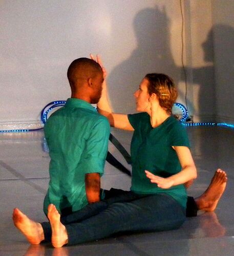 Two participants in movement together on the floor