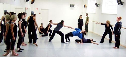 An ensemble of participants in movement in a studio
