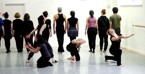 An ensemble of participants in movement in a studio
