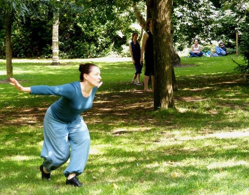 A participant in movement in a green space outdoors