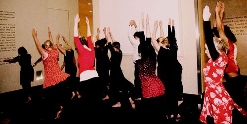 An ensemble of participants in movement in a gallery space