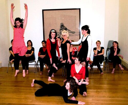 An ensemble of participants in movement in a gallery space