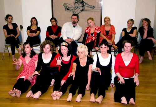An ensemble of participants in movement in a gallery space