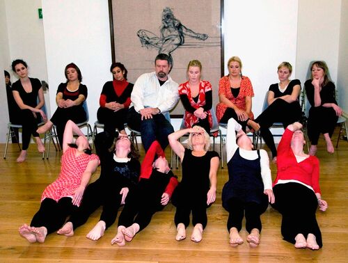 An ensemble of participants in movement in a gallery space