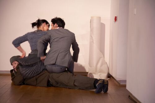 Two participants seated along another participant lying on the ground's back