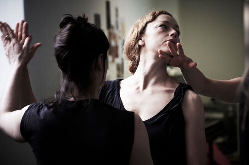 Two figures in movement in a studio