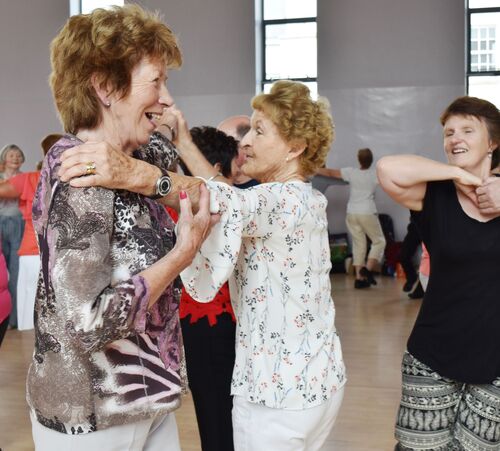 Participants dancing together in a hall
